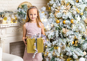 Caucasian father and daughter hanging Christmas wreath